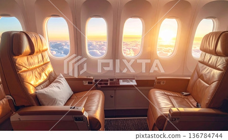Empty business class airplane interior featuring rows of red leather seats and a clean transport cabin with nobody inside Empty business class airplane interior featuring rows of red leather seats and a clean transport cabin with nobody inside 136784744