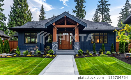 A new luxury residential estate features modern architecture with brick exterior and large windows nestled between a lush green garden lawn and a suburban wooded hill under a clear sky A new luxury residential estate features modern architecture with brick exterior and large windows nestled between a lush green garden lawn and a suburban wooded hill under a clear sky 136784764