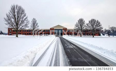 A scenic winter landscape featuring a frost covered house and snow covered bridge along a frozen city street under a blue sky A scenic winter landscape featuring a frost covered house and snow covered bridge along a frozen city street under a blue sky 136784853
