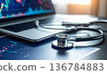 Medical stethoscope resting on a computer keyboard represents the rising cost of healthcare insurance and business finance in modern hospital clinics 136784883