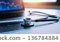 Medical stethoscope resting on a computer keyboard represents the rising cost of healthcare insurance and business finance in modern hospital clinics 136784884