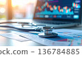 Medical stethoscope resting on a computer keyboard represents the rising cost of healthcare insurance and business finance in modern hospital clinics 136784885