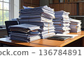 A large stack of old literature books and textbooks forms a colorful pile on a library desk, representing a wealth of knowledge and education through reading 136784891