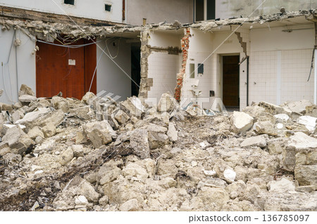 Destroyed residential building surrounded by debris due to demolition, earthquake damage, war attack or structural failure, urban disaster concept Destroyed residential building surrounded by debris due to demolition, earthquake damage, war attack or structural failure, urban disaster concept 136785097