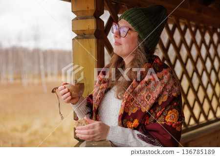 Warm moments of serenity while sipping tea on a chilly autumn day in a cozy countryside setting 136785189