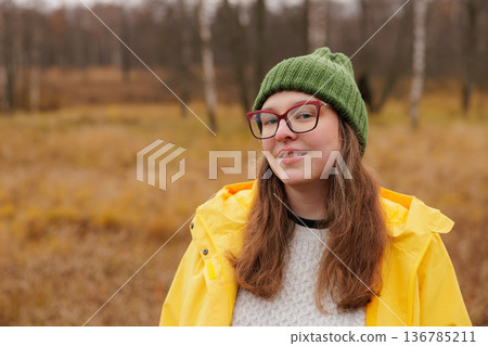 Enjoying a brisk autumn day with warmth and color in a cozy landscape of golden grass and trees Enjoying a brisk autumn day with warmth and color in a cozy landscape of golden grass and trees 136785211