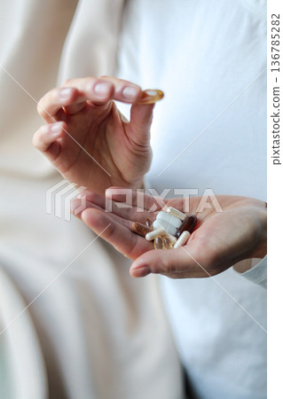 Pills and health supplements. Woman is taking supplements 136785282