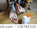 Pills and health supplements. Woman is taking supplements 136785320