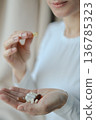 Pills and health supplements. Woman is taking supplements 136785323