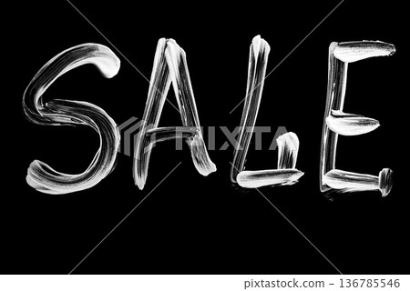 Bold white brush script word SALE for retail promotion on black background 136785546