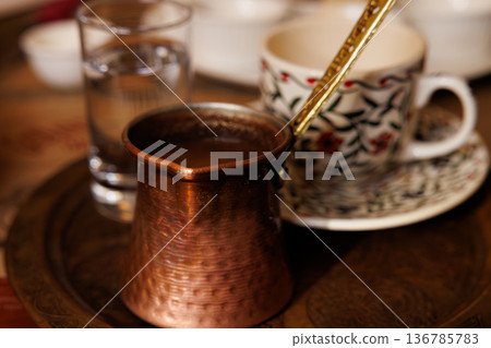 Traditional Turkish coffee served with sparkling water on a decorative tray 136785783
