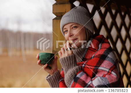 Cozy moments with warm tea and a snack in a serene autumn setting 136785823