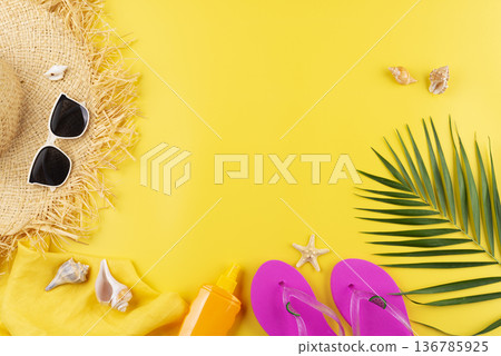 Vacation planning simple theme of straw hat sunglasses flip flops and palm leaves on uniform yellow background flat lay with copy-space Vacation planning simple theme of straw hat sunglasses flip flops and palm leaves on uniform yellow background flat lay with copy-space 136785925