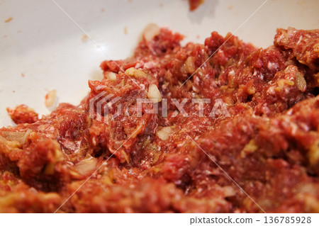 Ground meat preparation in a cozy kitchen setting at afternoon light 136785928
