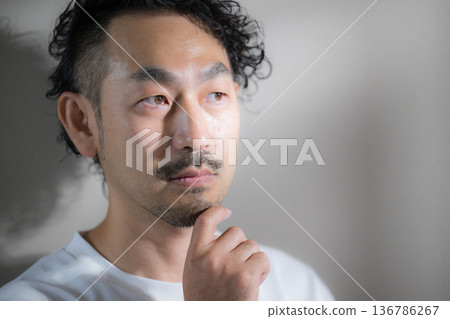 Image of a handsome middle-aged man with a beard, hair removal and beard, close-up of skin care, touching his chin, worrying and thinking Image of a handsome middle-aged man with a beard, hair removal and beard, close-up of skin care, touching his chin, worrying and thinking 136786267