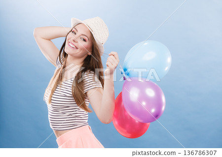 Woman summer joyful girl with colorful balloons 136786307