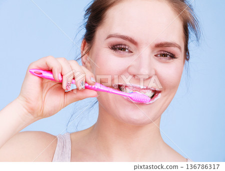 Woman brushing cleaning teeth Woman brushing cleaning teeth 136786317