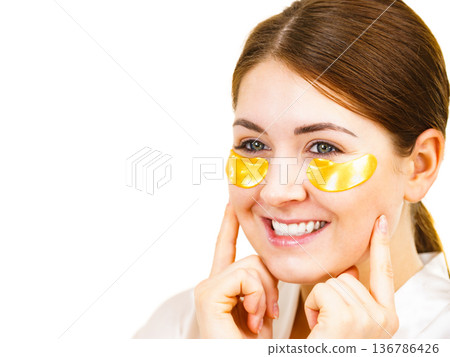 Woman with gold patches under eyes 136786426