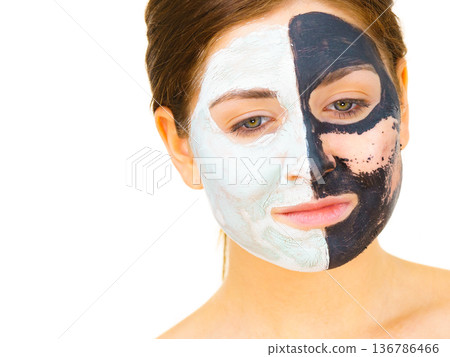 Girl remove black white mud mask from face Girl remove black white mud mask from face 136786466