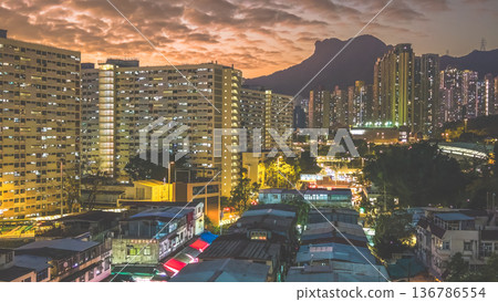 Night market walkway glowing beneath towering city skyline Feb 5 2026 136786554