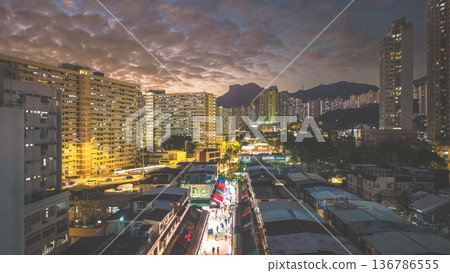 Night market walkway glowing beneath towering city skyline Feb 5 2026 136786555