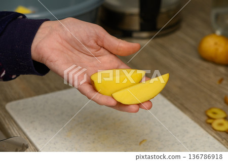 Preparing Potato Wedges for Oven Roasting Preparing Potato Wedges for Oven Roasting 136786918