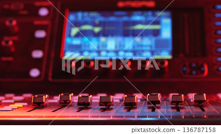 Mixing Console Faders In Foreground Close Up, Blurred Equalizer Screen In Background, Music Production Technology Copy Space Mixing Console Faders In Foreground Close Up, Blurred Equalizer Screen In Background, Music Production Technology Copy Space 136787158