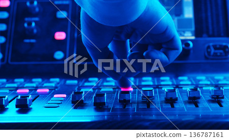 Sound Engineer Adjusting Mixer Fader Close Up, Stage Console Controlling Live Levels, Summer Music Festival Concert Nightlife Sound Engineer Adjusting Mixer Fader Close Up, Stage Console Controlling Live Levels, Summer Music Festival Concert Nightlife 136787161