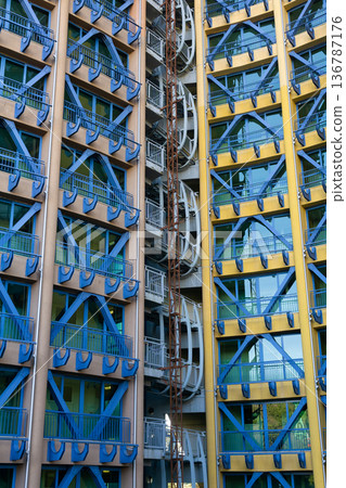 Facade of a multi-storey building with blue metal structures 136787176