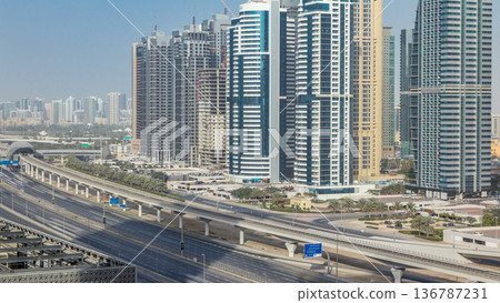 Aerial view of Jumeirah lakes towers skyscrapers timelapse with traffic on sheikh zayed road. Aerial view of Jumeirah lakes towers skyscrapers timelapse with traffic on sheikh zayed road. 136787231