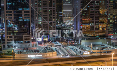 Aerial view of Jumeirah lakes towers skyscrapers night timelapse with traffic on sheikh zayed road. Aerial view of Jumeirah lakes towers skyscrapers night timelapse with traffic on sheikh zayed road. 136787241