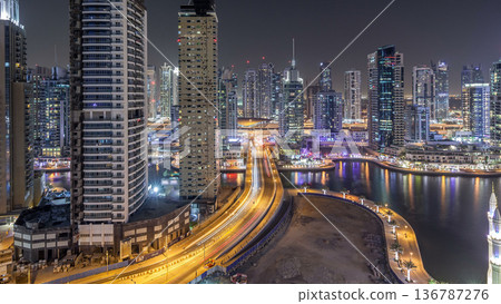 Water canal on Dubai Marina skyline at night timelapse. Water canal on Dubai Marina skyline at night timelapse. 136787276