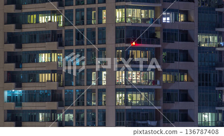 Glowing windows of skyscrapers at evening timelapse Glowing windows of skyscrapers at evening timelapse 136787408