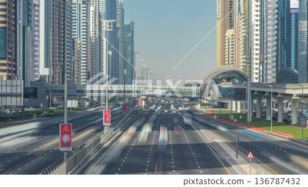 Busy Sheikh Zayed Road timelapse, metro railway and modern skyscrapers around in luxury Dubai city Busy Sheikh Zayed Road timelapse, metro railway and modern skyscrapers around in luxury Dubai city 136787432
