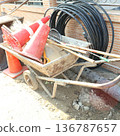 Construction Site Equipment Set - Industrial Water Pipes, Wheelbarrow, and Traffic Cones 136787657