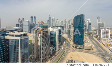 Dubai business bay towers at day time aerial timelapse. Dubai business bay towers at day time aerial timelapse. 136787721
