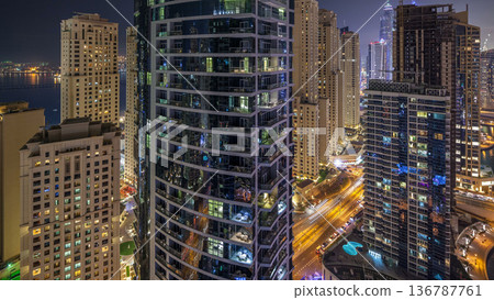 Night illumination of Dubai Marina aerial timelapse, UAE. Night illumination of Dubai Marina aerial timelapse, UAE. 136787761