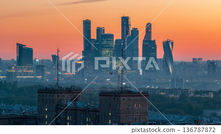 Cityscape night to day timelapse, residential buildings, park areas, group of Moscow City skyscrapers 136787872