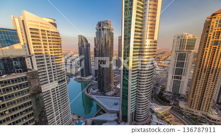 Top view of buildings Jumeirah Lakes Towers with traffic on the road sunset timelapse. Top view of buildings Jumeirah Lakes Towers with traffic on the road sunset timelapse. 136787911