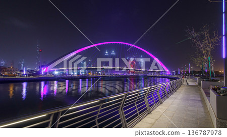 Pedestrian Bridge over the Dubai Water Canal night timelapse hyperlapse, United Arab Emirates 136787978