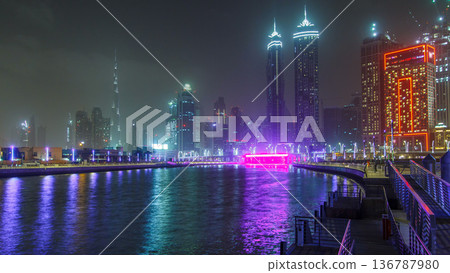 Illuminated Waterfall at the Sheikh Zayed Bridge timelapse, part of the Dubai Water Canal. Dubai, United Arab Emirates, Middle East 136787980