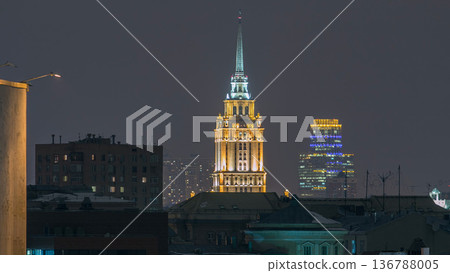 Hotel Ukraine with roofs timelapse, landmark near historic center of Moscow. Cityscape in snowy winter evening. Hotel Ukraine with roofs timelapse, landmark near historic center of Moscow. Cityscape in snowy winter evening. 136788005