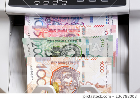 Kazakhstani tenge in a counting machine Kazakhstani tenge in a counting machine 136788008