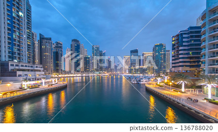 Evening Dubai marina city center with floating vessels day to night timelapse Evening Dubai marina city center with floating vessels day to night timelapse 136788020