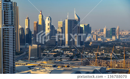Dubai downtown skyline timelapse at sunset time. Rooftop view of Sheikh Zayed road with numerous towers. Dubai downtown skyline timelapse at sunset time. Rooftop view of Sheikh Zayed road with numerous towers. 136788070