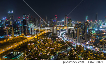 Aerial view of a big modern city at night timelapse. Business bay, Dubai, United Arab Emirates. Aerial view of a big modern city at night timelapse. Business bay, Dubai, United Arab Emirates. 136788071