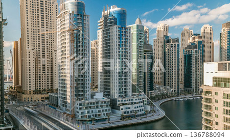 Dubai Marina at evening timelapse with trails of boats on the water and cars traffic, Dubai, UAE Dubai Marina at evening timelapse with trails of boats on the water and cars traffic, Dubai, UAE 136788094