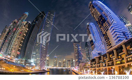 Dubai Marina towers and canal in Dubai day to night timelapse 136788100