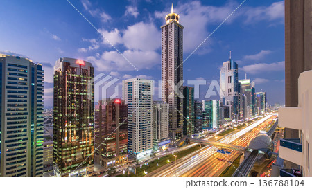 Downtown Dubai towers day to night timelapse. Aerial view of Sheikh Zayed road with skyscrapers after sunset. 136788104