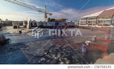 Roofer installing roofing felt with heating and melting of bitumen roll by torch on flame during roof repair timelapse Roofer installing roofing felt with heating and melting of bitumen roll by torch on flame during roof repair timelapse 136788143